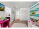 Bright bedroom featuring a whimsical striped accent wall and pink accents at 12972 Uinta Ct, Thornton, CO 80602