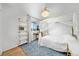 A beautifully decorated bedroom with a four poster bed, bookshelf, and ceiling fan at 12972 Uinta Ct, Thornton, CO 80602