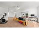 A finished bonus room featuring a Peloton bike, weights and tv at 12972 Uinta Ct, Thornton, CO 80602