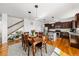 Open concept eat-in kitchen and Gathering room space with stone countertops and hardwood floors at 12972 Uinta Ct, Thornton, CO 80602