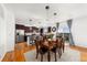 Bright eat-in kitchen with stainless steel appliances, dark cabinetry, and dining table near patio doors at 12972 Uinta Ct, Thornton, CO 80602