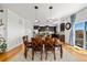 Beautiful open dining area featuring hardwood floors, stylish lighting, and easy access to the outdoor patio at 12972 Uinta Ct, Thornton, CO 80602