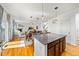 Open concept eat-in kitchen and Gathering room space with stone countertops and hardwood floors at 12972 Uinta Ct, Thornton, CO 80602