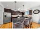 Kitchen featuring stainless steel appliances, granite countertops, and a breakfast bar with seating for three at 12972 Uinta Ct, Thornton, CO 80602