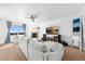 Inviting living room with a fireplace, plush sofa, and large windows offering abundant natural light at 12972 Uinta Ct, Thornton, CO 80602