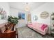 Cozy living room featuring a pink sofa, piano, and stylish decor, creating a unique and inviting space at 12972 Uinta Ct, Thornton, CO 80602