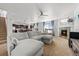 Bright, open-concept living room featuring a fireplace, modern furnishings, and seamless flow to the dining area at 12972 Uinta Ct, Thornton, CO 80602