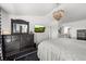 Bright and airy main bedroom with a decorative chandelier, hardwood floors, and ample closet space at 12972 Uinta Ct, Thornton, CO 80602