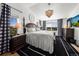 Inviting main bedroom with a large bed, decorative chandelier, and scenic outdoor views from the windows at 12972 Uinta Ct, Thornton, CO 80602