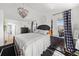 Inviting main bedroom with a large bed, decorative chandelier, and scenic outdoor views from the windows at 12972 Uinta Ct, Thornton, CO 80602
