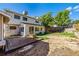 Large backyard features a deck, lush lawn and a sunroom at 9805 Garrison Ct, Broomfield, CO 80021