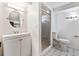 Bright bathroom with white vanity, oval mirror, glass shower, and updated tiling at 9805 Garrison Ct, Broomfield, CO 80021