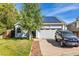 Inviting home exterior featuring solar panels, a well-kept lawn, and an attached two-car garage at 9805 Garrison Ct, Broomfield, CO 80021