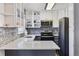 Updated kitchen featuring stainless steel appliances, stone backsplash, and open shelving at 9805 Garrison Ct, Broomfield, CO 80021