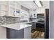 Modern kitchen with grey cabinets, stone backsplash, stainless steel appliances and hardwood floors at 9805 Garrison Ct, Broomfield, CO 80021