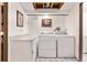 Functional laundry room equipped with washer, dryer, counter space, and ample storage at 9805 Garrison Ct, Broomfield, CO 80021