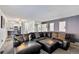 Open-concept living space with hardwood floors, a cozy seating area, and natural light at 9805 Garrison Ct, Broomfield, CO 80021
