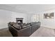 Comfortable living room with a cozy fireplace and large sectional sofa and large window at 9805 Garrison Ct, Broomfield, CO 80021