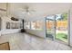 Bright sun room with tile flooring, wood stove, and multiple windows overlooking the fenced backyard at 9805 Garrison Ct, Broomfield, CO 80021