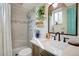 Stylish bathroom with tiled shower, modern vanity, and decorative accents at 1050 N Lafayette St # 408, Denver, CO 80218