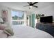 Bright bedroom with a ceiling fan, large window, white bedspread, and light-filled space at 1050 N Lafayette St # 408, Denver, CO 80218