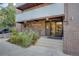 Condominium building entrance featuring brickwork, signage, and well-maintained landscaping at 1050 N Lafayette St # 408, Denver, CO 80218