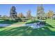 Beautiful community park with walking path and benches surrounded by lush greenery and mature trees at 1050 N Lafayette St # 408, Denver, CO 80218