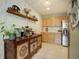 Updated kitchen featuring wood cabinets, stainless steel refrigerator and decorative shelving at 1050 N Lafayette St # 408, Denver, CO 80218