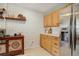 Updated kitchen featuring wood cabinets, stainless steel refrigerator and decorative shelving at 1050 N Lafayette St # 408, Denver, CO 80218