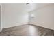 Bright bedroom features new gray wood-style flooring and a window offering natural light at 5547 Himalaya Rd, Denver, CO 80249