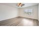 Bright bedroom featuring large window, a ceiling fan, and durable gray flooring at 5547 Himalaya Rd, Denver, CO 80249