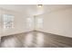Bedroom with three windows providing natural light and durable gray flooring at 5547 Himalaya Rd, Denver, CO 80249