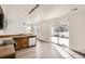 Modern kitchen featuring stainless steel appliances, wood cabinets, and a sliding glass door to the patio at 5547 Himalaya Rd, Denver, CO 80249
