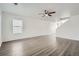 Bright, spacious living room with hardwood floors, natural light, and a ceiling fan at 5547 Himalaya Rd, Denver, CO 80249
