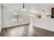 Bright, spacious living room with hardwood floors and neutral walls with an open concept at 5547 Himalaya Rd, Denver, CO 80249