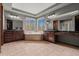 Luxurious bathroom with dual vanities, a large soaking tub, and plenty of natural light at 25312 E Glasgow Pl, Aurora, CO 80016