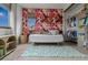 Bright, cheerful bedroom with a daybed, floral wallpaper, and ample closet space at 25312 E Glasgow Pl, Aurora, CO 80016