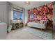 Charming bedroom featuring a daybed, colorful wallpaper, and built-in bookcase at 25312 E Glasgow Pl, Aurora, CO 80016