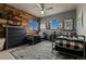 Shared bedroom featuring two beds, wood-paneled wall, and ample natural light at 25312 E Glasgow Pl, Aurora, CO 80016