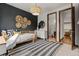 Well-appointed bedroom with daybed, decorative wall art, and adjacent bathroom at 25312 E Glasgow Pl, Aurora, CO 80016