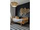 Bright bedroom featuring a daybed, patterned rug, and modern chandelier at 25312 E Glasgow Pl, Aurora, CO 80016