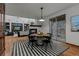 Open-concept dining area with a fireplace and views of the living room and backyard at 25312 E Glasgow Pl, Aurora, CO 80016
