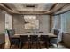 Modern dining room featuring a wood table and seating with wainscoting and stylish chandelier at 25312 E Glasgow Pl, Aurora, CO 80016