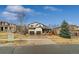 Exterior view of a two-story home featuring a three-car garage and a landscaped yard at 25312 E Glasgow Pl, Aurora, CO 80016