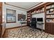 Comfortable home office featuring wood built-ins and a large patterned area rug at 25312 E Glasgow Pl, Aurora, CO 80016