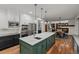 Open kitchen with an island, stainless steel appliances, and an adjacent dining area at 25312 E Glasgow Pl, Aurora, CO 80016