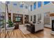 Spacious living room with high ceilings, built-in shelving, and large windows at 25312 E Glasgow Pl, Aurora, CO 80016