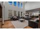 Bright living room featuring high ceilings, large windows, and a cozy fireplace at 25312 E Glasgow Pl, Aurora, CO 80016