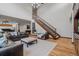 Spacious living room with hardwood floors, staircase, and comfortable seating area at 25312 E Glasgow Pl, Aurora, CO 80016
