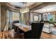 Elegant dining and living room featuring a grand piano, stylish seating, and hardwood floors at 25312 E Glasgow Pl, Aurora, CO 80016